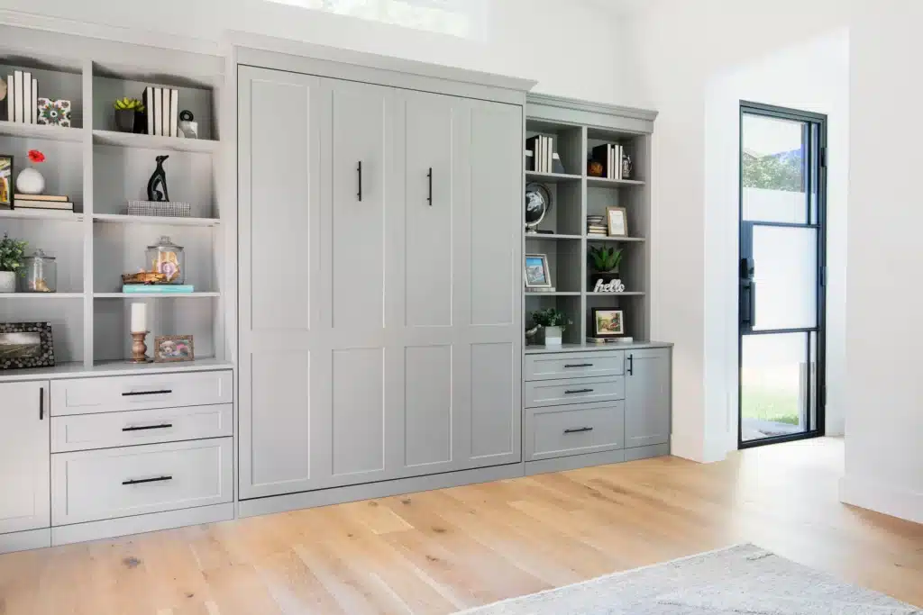 A Murphy bed with side cabinet storage in grey shaker.